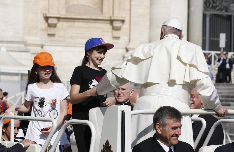 Children join Pope Francis in the popemobile during his general audience in St. Peter's Square at the Vatican June 5