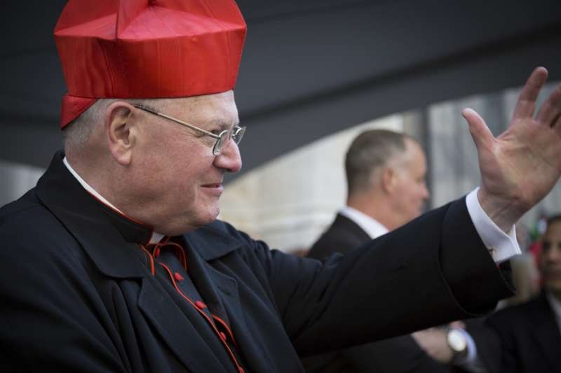 Timothy Cardinal Dolan Archbishop of New York waves to parade marchers in front of St Patricks Cathedral on Saint Patricks Day in Manhattan on March 17