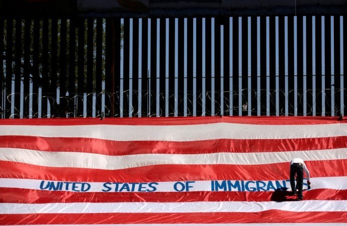 A protester near a border wall in El Paso