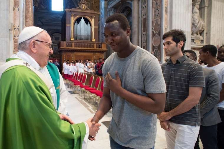 Pope Francis greets migrants July 6