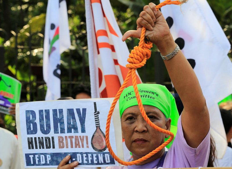 A woman holds up a noose during a Feb. 18