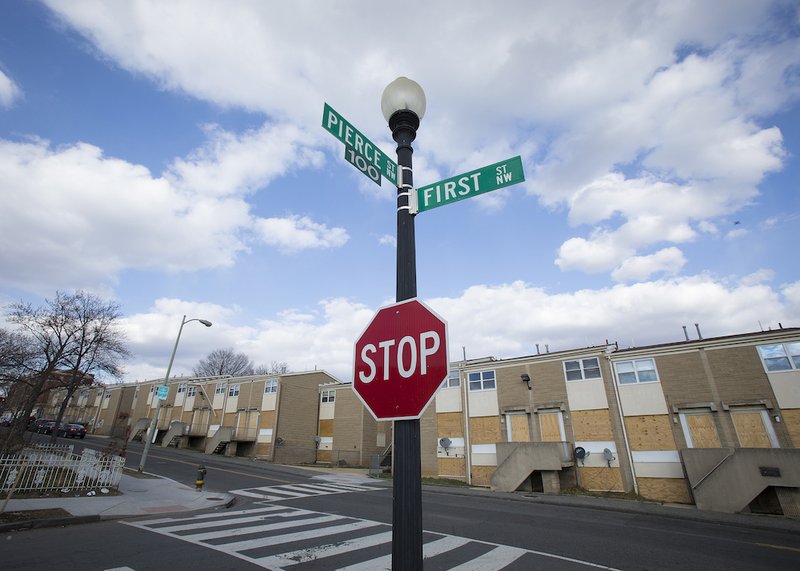 A row of boarded-up houses is seen in downtown Washington March 13