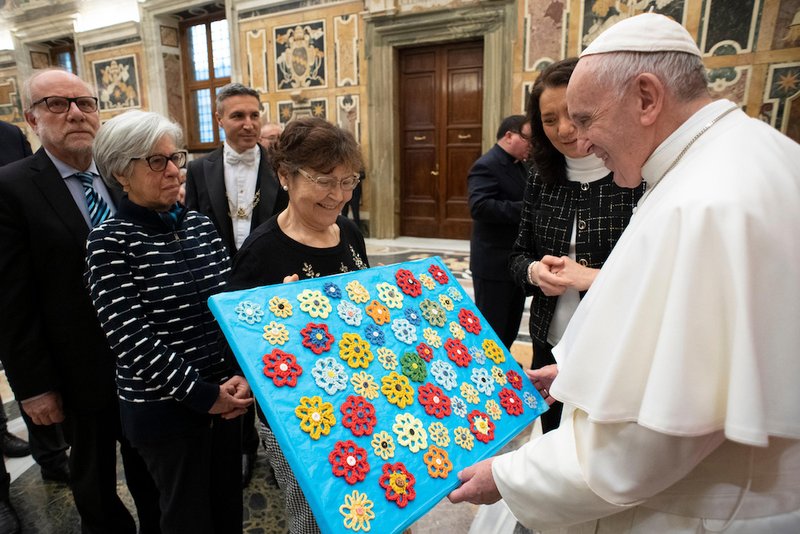 Pope Francis receives a gift from a member of the board of directors of Italy's pro-life movement during a Vatican audience Feb. 2