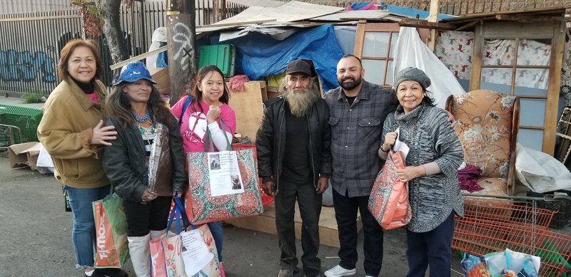Parishioners from St. John of God hand out Care Bags to the homeless. (PHOTO COURTESY ST. JOHN OF GOD PARISH)