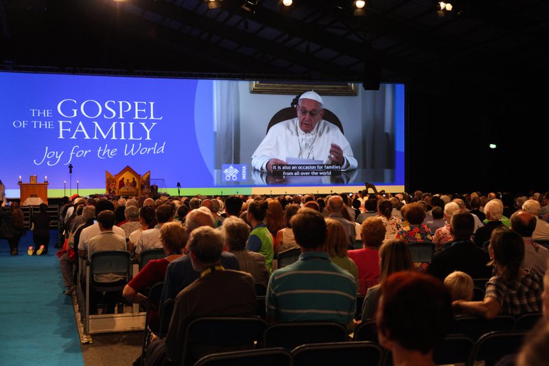 Attendees watch Pope Francis on a screen during the opening ceremony of the World Meeting of Families in Dublin Aug. 21. (CNS photo/courtesy John McElroy