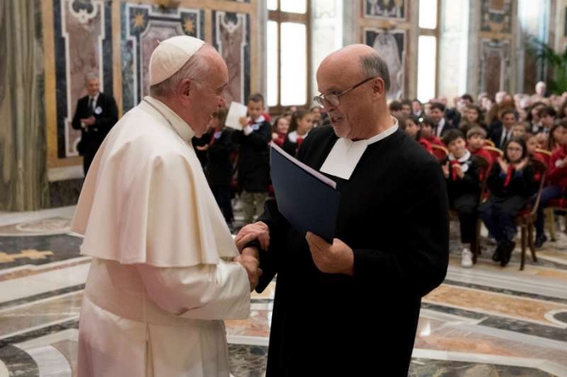 Pope Francis greets a representative of the De La Salle Brothers at the Vatican's Clementine Hall