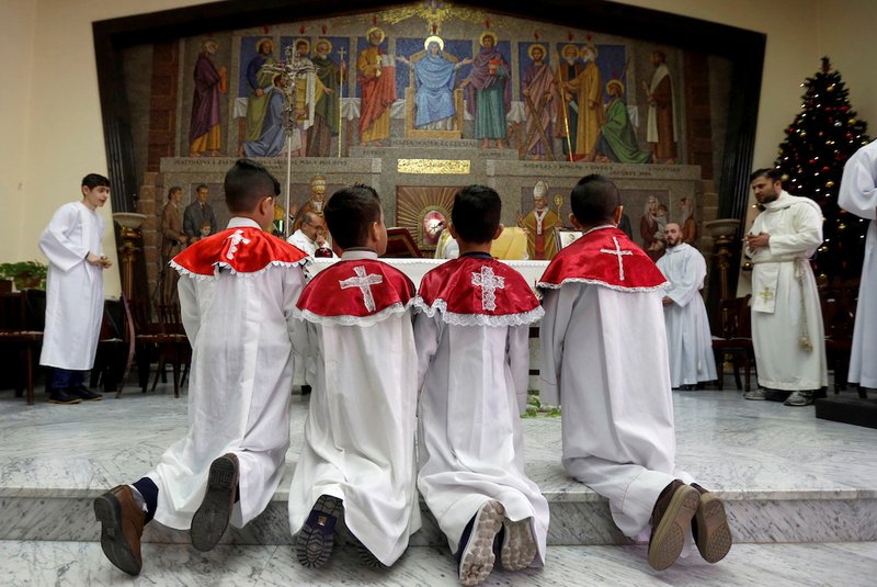 Displaced Iraqi Christian boys serve Mass Dec. 24