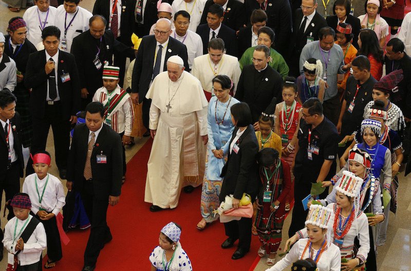 Pope Francis walks with Aung San Suu Kyi