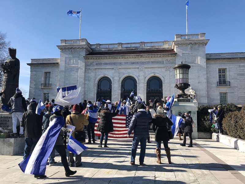 Demonstrators gather outside the Organization of American States building in Washington Jan. 11
