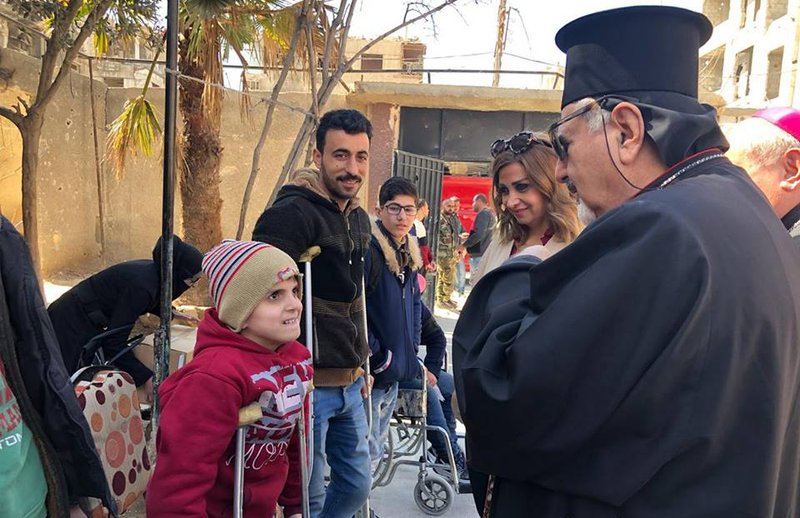 Syriac Catholic Patriarch Ignace Joseph III Younan meets injured people in Douma