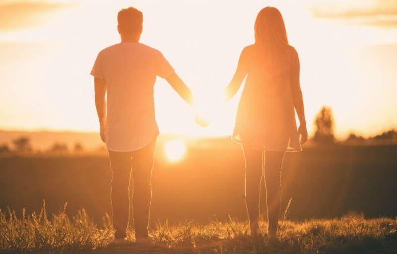Couple holding hands at sunset. Credit: Ryan Holloway via Unsplash