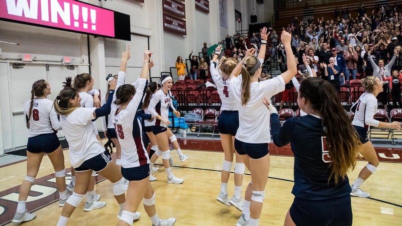 LMU girls' volleyball team celebrates their win. (PHOTO COURTESY LOYOLA MARYMOUNT LIONS) 