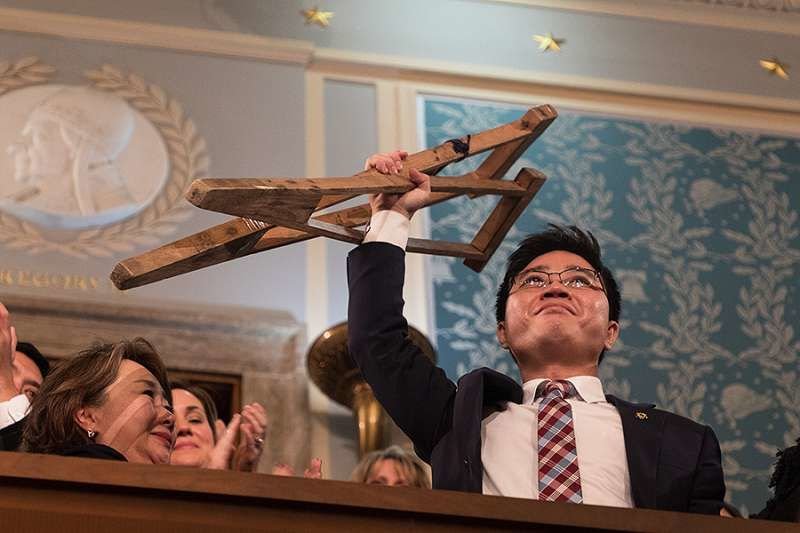 Ji Seong-ho holds his crutches at the 2018 State of the Union address. Public Domain.