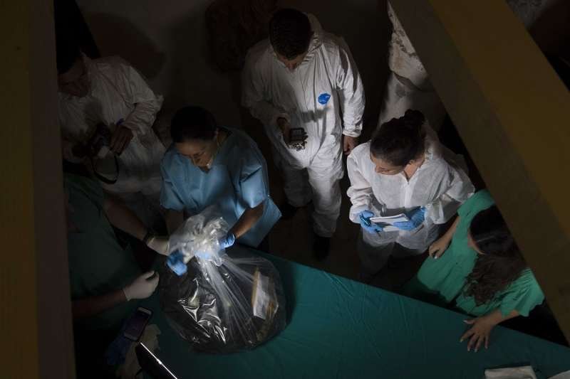 Scientists study bones found under a floor in the Teutonic College. Credit: Vatican Media.