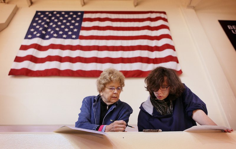 Beverly Moore helps her grandson Johnah Karman-Moore vote for the first time at Bellarmine University in Louisville