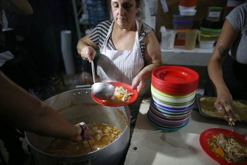Women prepare food at a soup kitchen in Buenos Aires