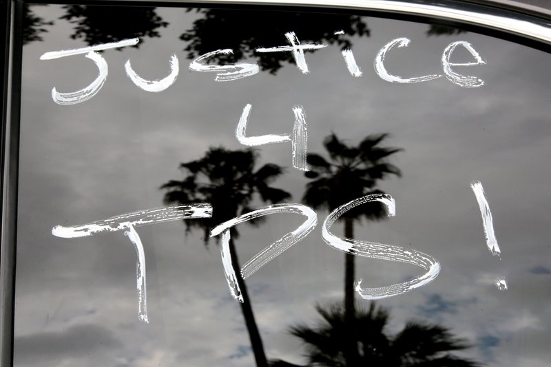 "Justice 4 TPS" is seen Oct. 3 on a car window in Los Angeles. U.S. District Court Judge Edward Chen of the Northern District of California Oct. 3 issued a preliminary injunction to stop cancellation of Temporary Protected Status
