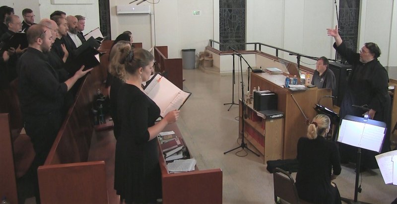 Steven Ottomanyi (right) leads a rehearsal of the Chorus Angelorum that he will direct in “Mission Echoes