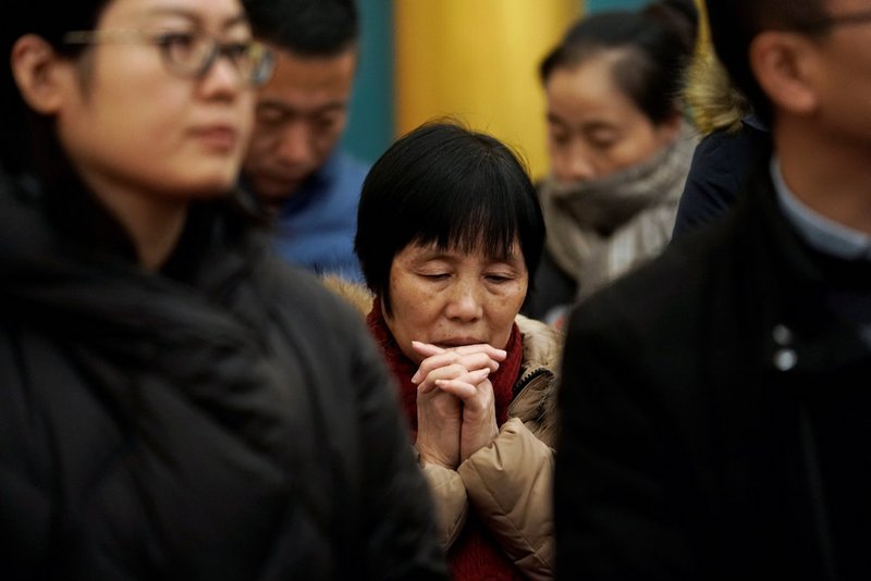 Chinese Catholics pray during Christmas Eve Mass at the Church of St. Saviour in Beijing. (CNS photo/Jason Lee