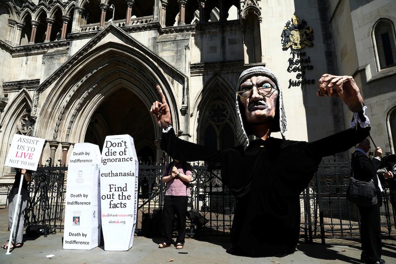 Anti-euthanasia protesters demonstrate outside the Royal Courts of Justice in London July 17