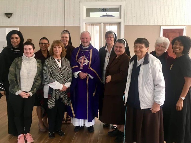 Bishop O'Connell poses with the Felician Sisters and associates after Mass on Sunday