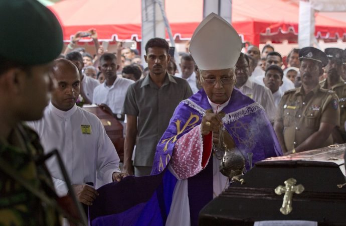 Cardinal Malcolm Ranjith delivers funeral rituals during a funeral service for Easter Sunday bomb blast victims at St. Sebastian Church in Negombo
