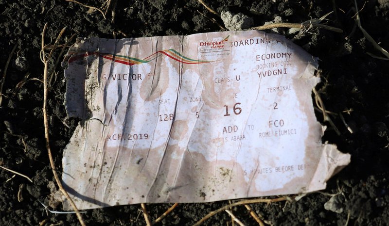 A boarding pass is seen at the scene of the Ethiopian Airlines Flight ET 302 plane crash May 11