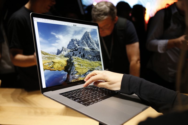 People look at new computers in Cupertino