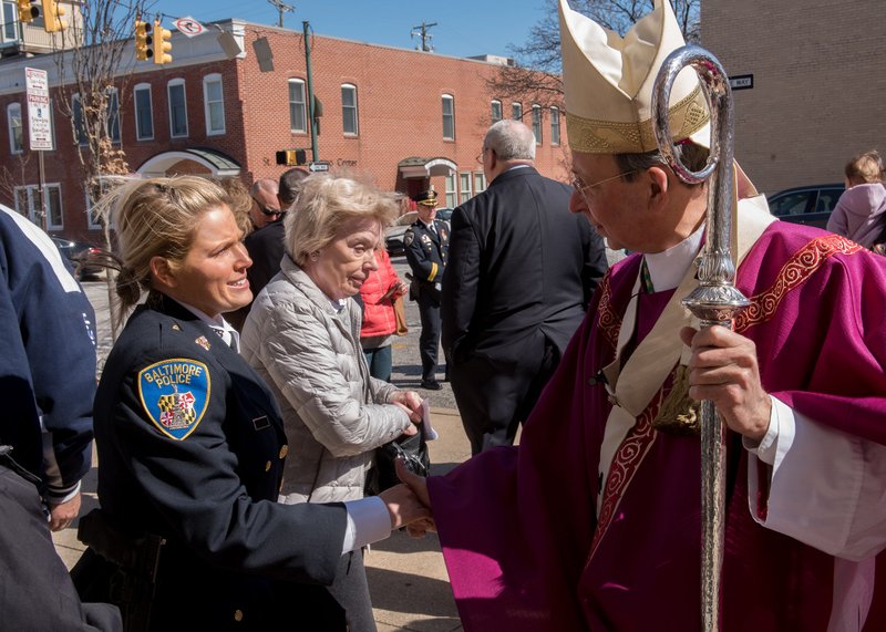 Baltimore Archbishop William E. Lori greets Baltimore City Police Detective Ashley Acord following the Blue Mass for the city's police March 4 at St. Casimir Church in Baltimore's Canton neighborhood. (CNS photo/Kevin J. Parks