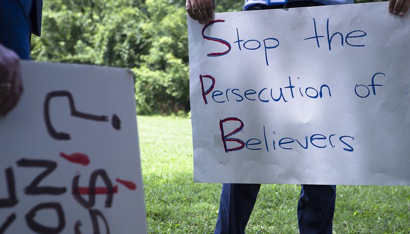 A participant holds a sign at a Religious Freedom Rally in Washington, D.C., July 10. It was one of several rallies held the same day in cities around the country and sponsored by Save the Persecuted Christians. (CNS photo/Tyler Orsburn)