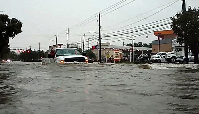 A car passes through a flooded street Sept. 19, 2019, as Tropical Storm Imelda hits Houston as seen in this screen grab obtained from social media video. As floodwaters began slowing receding in Houston Sept. 20, police worked to clear freeways of hundreds of stranded vehicles after four days of relentless rain and deadly flooding along the southeast Texas Gulf coast from the remnants of Imelda. (CNS photo/@kingjames.daniel/ via Reuters)