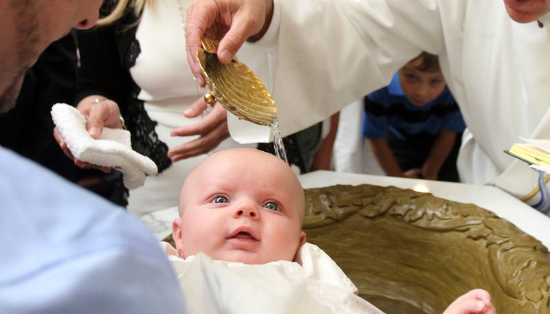 A baby is seen during her baptism. France's Catholic bishops criticized legislation to allow medically assisted procreation for single mothers and lesbian couples and urged citizens to help block its enactment. (CNS photo/Gregory A. Shemitz)