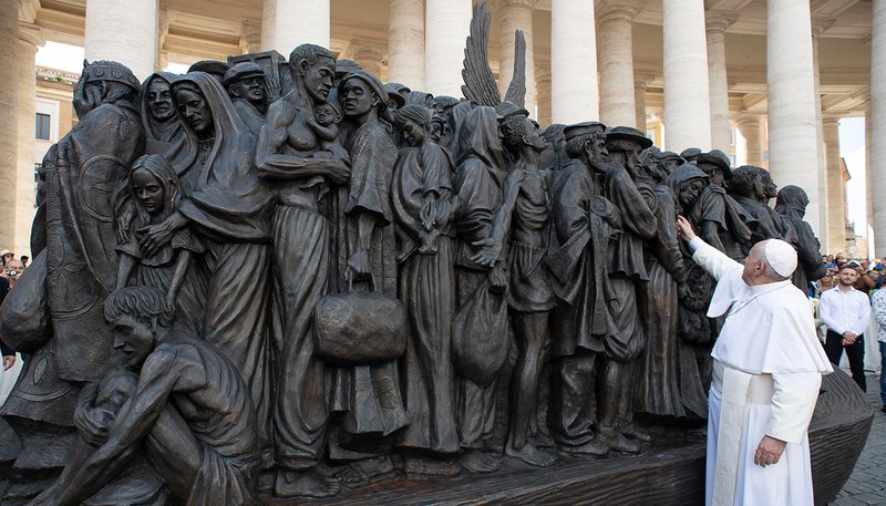 Pope Francis attends the unveiling of a large bronze statue titled, "Angels Unawares," by Canadian artist Timothy Schmalz, in St. Peter's Square at the Vatican Sept. 29, 2019. The statue depicts a group of migrants and refugees on a boat. (CNS photo/Vatican Media)
