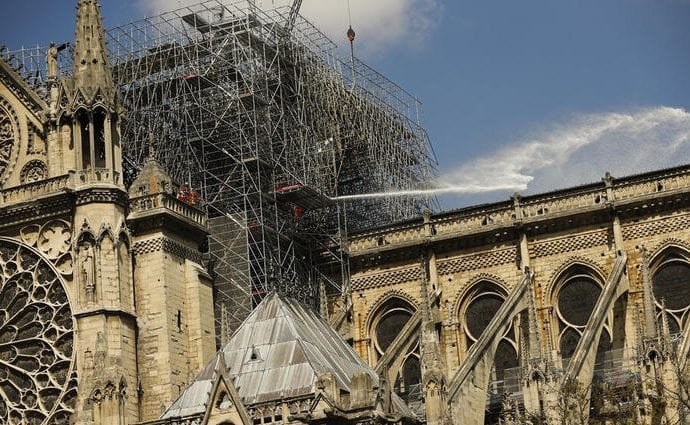 Firefighters work with a hose at the Notre Dame cathedral in Paris