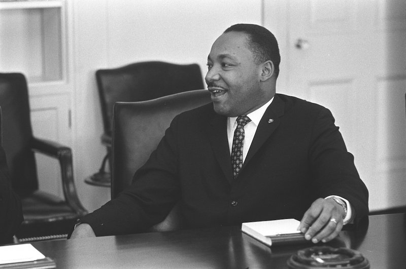Civil rights leader the Rev. Martin Luther King Jr. smiles during a talk with U.S. President Lyndon B. Johnson