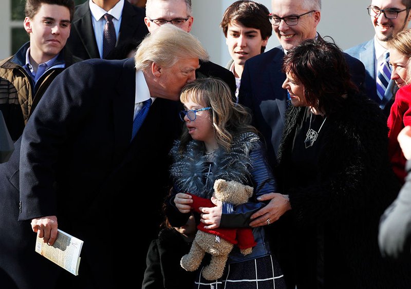 President Donald Trump greets a girl after addressing attendees of the annual March for Life rally from the Rose Garden of the White House in Washington Jan. 19. The live feed was projected onto a large video screen during the rally on the National Mall. (CNS photo/Kevin Lamarque