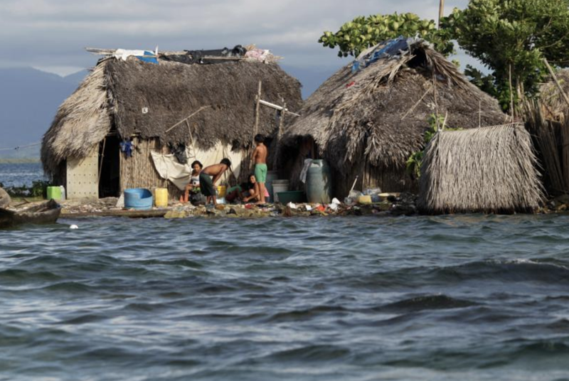 Indigenous Guna residents stand outside a house in Panama's Carti Sugdub island Sept. 4