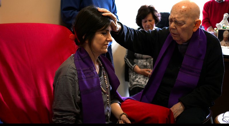 Pauline Father Gabriele Amorth performs an exorcism on Christina in the documentary "The Devil and Father Amorth." (CNS PHOTO/LD ENTERTAINMENT)