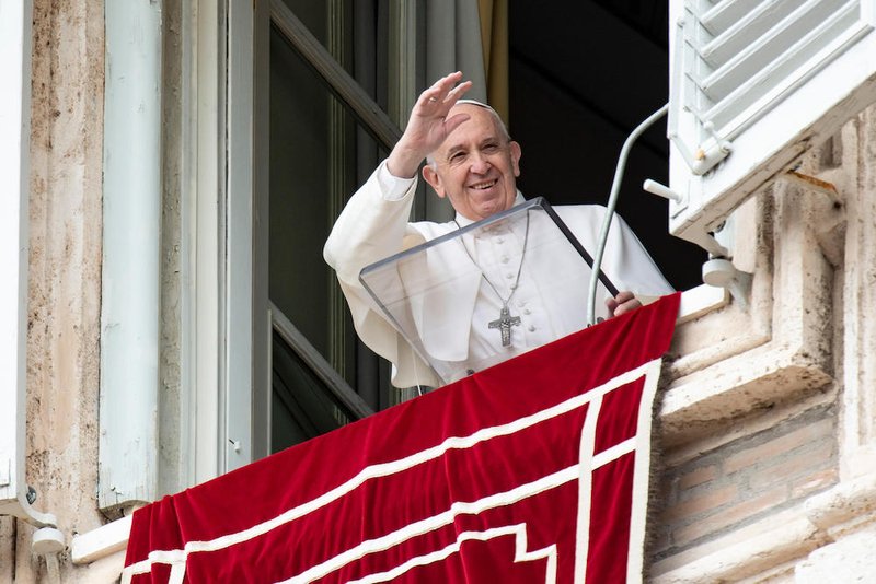 Pope Francis waves as he leads the "Regina Coeli" from the window of his studio overlooking St. Peter's Square at the Vatican April 28