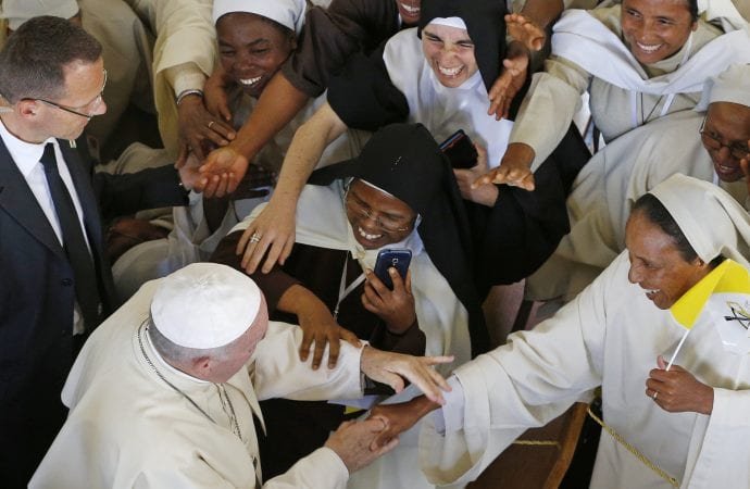 Pope Francis greets nuns after attending the recitation of midday prayer in the Discalced Carmelite Monastery in Antananarivo