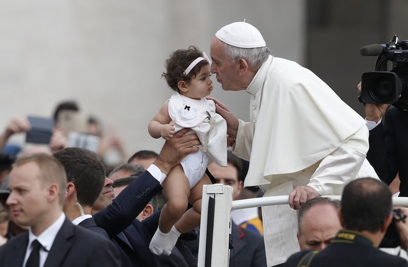 Pope Francis greets the crowd during his general audience in St. Peter's Square at the Vatican Sept. 19. (CNS photo/Paul Haring)