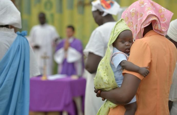 A mother holds her child during Mass in 2014 in Juba