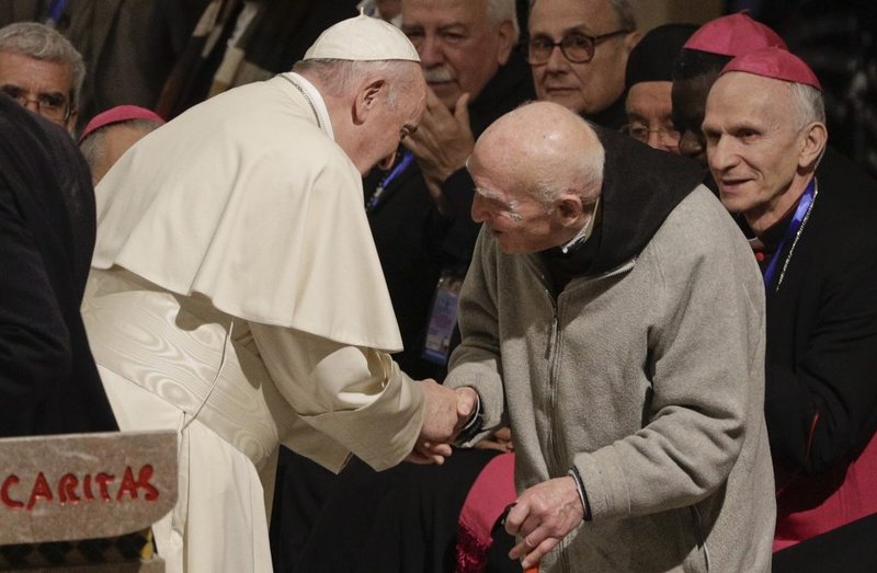 Pope Francis greets father Jean-Pierre Schumacher
