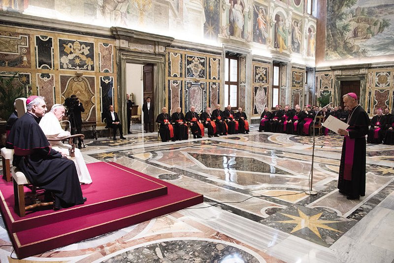 Pope Francis listens as Archbishop Luis Ladaria Ferrer