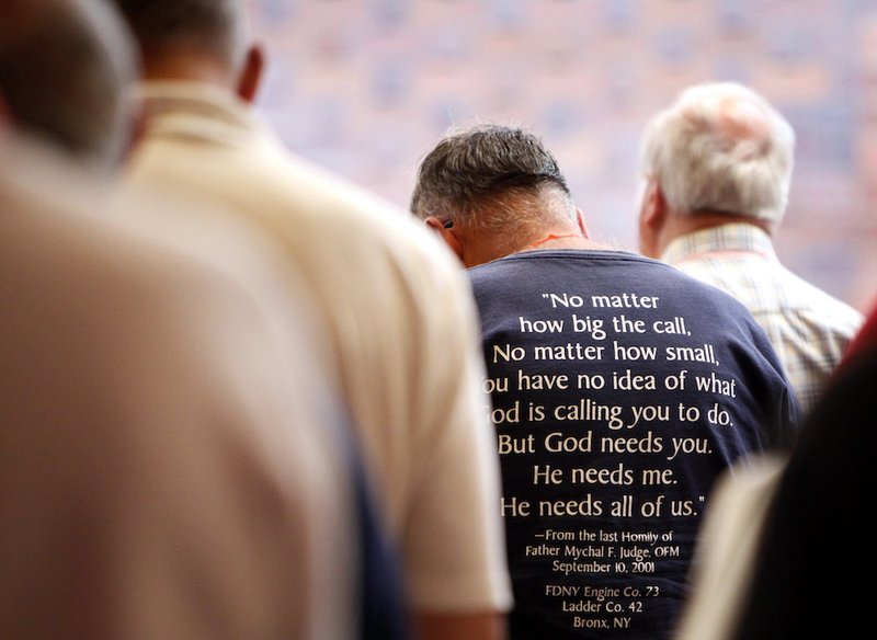 Members of the Association of U.S. Catholic Priests bow their heads in prayer at a Mass during the organization's gathering in Chicago in 2016. (CNS photo/Karen Callaway