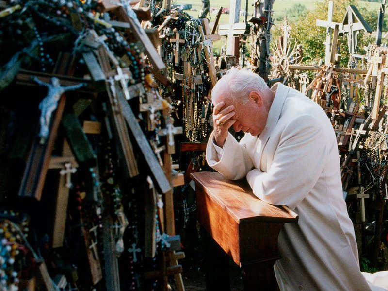 St. Pope John Paul II (pictured at Lithuania’s Hill of Crosses in 1993) consistently promoted the rosary as a prayer for peace. (CNS/L’OSSERVATORE ROMANO)