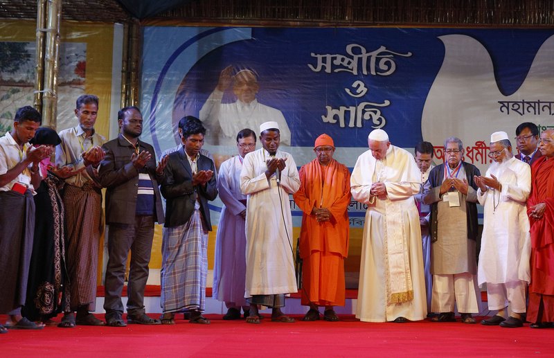 Pope Francis prays with religious leaders and Rohingya refugees from Myanmar during an interreligious and ecumenical meeting for peace at the archbishop's residence in Dhaka