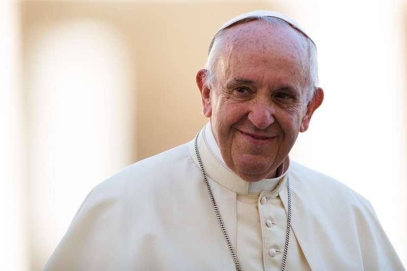 Pope Francis smiles during an encounter in St. Peter's Square Oct. 14