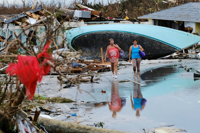 Women walk amid rubble Sept. 3