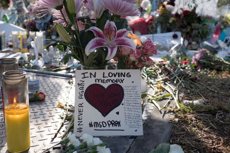 Flowers and mementos are seen at a memorial at Marjory Stoneman Douglas High School in Parkland